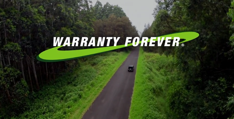 The Warranty Forever logo over a Chevrolet driving down the road in Newton Falls, OH